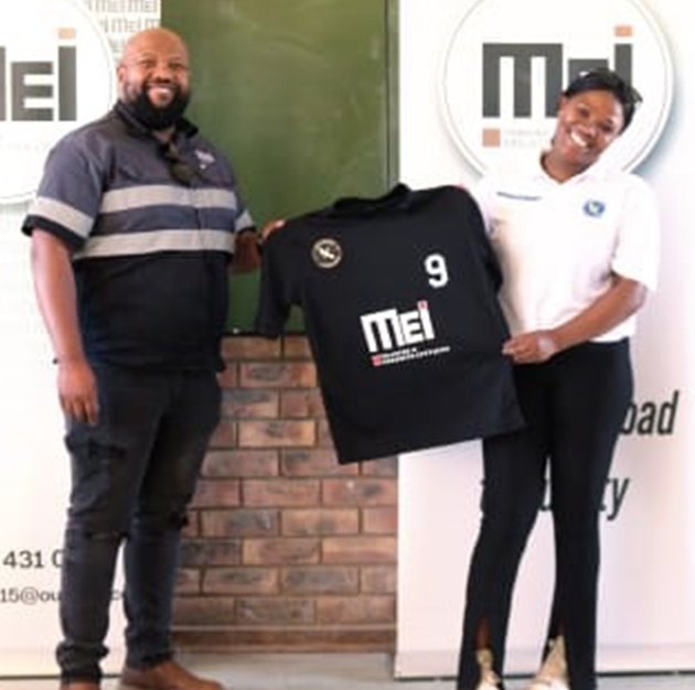 MEI handing over a sponsored football jersey